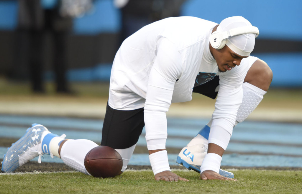 Jan 24, 2016; Charlotte, NC, USA; Carolina Panthers quarterback Cam Newton (1) puts his hands on the field during warm-ups prior to the game against the Arizona Cardinals in the NFC Championship football game at Bank of America Stadium. Mandatory Credit: John David Mercer-USA TODAY Sports